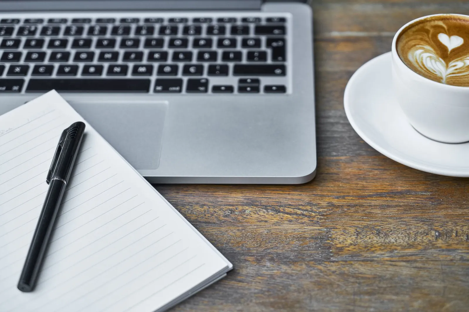 A games-business journalist reviewing funding notes on a laptop at a desk